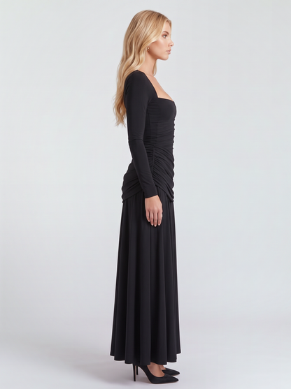 Women black long sleeve ruched maxi dress with a fitted bodice and a flowing skirt, side view