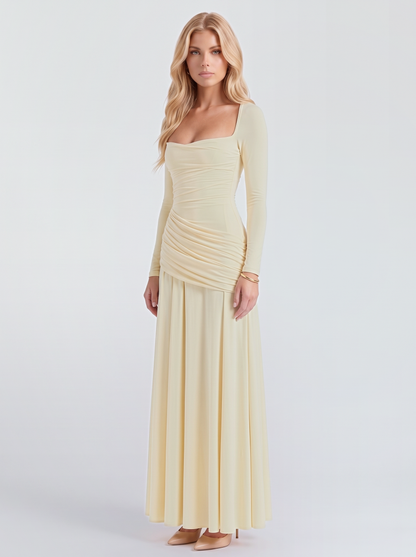 Women cream long sleeve ruched maxi dress with a draped hip and a flowing skirt, three quarter view