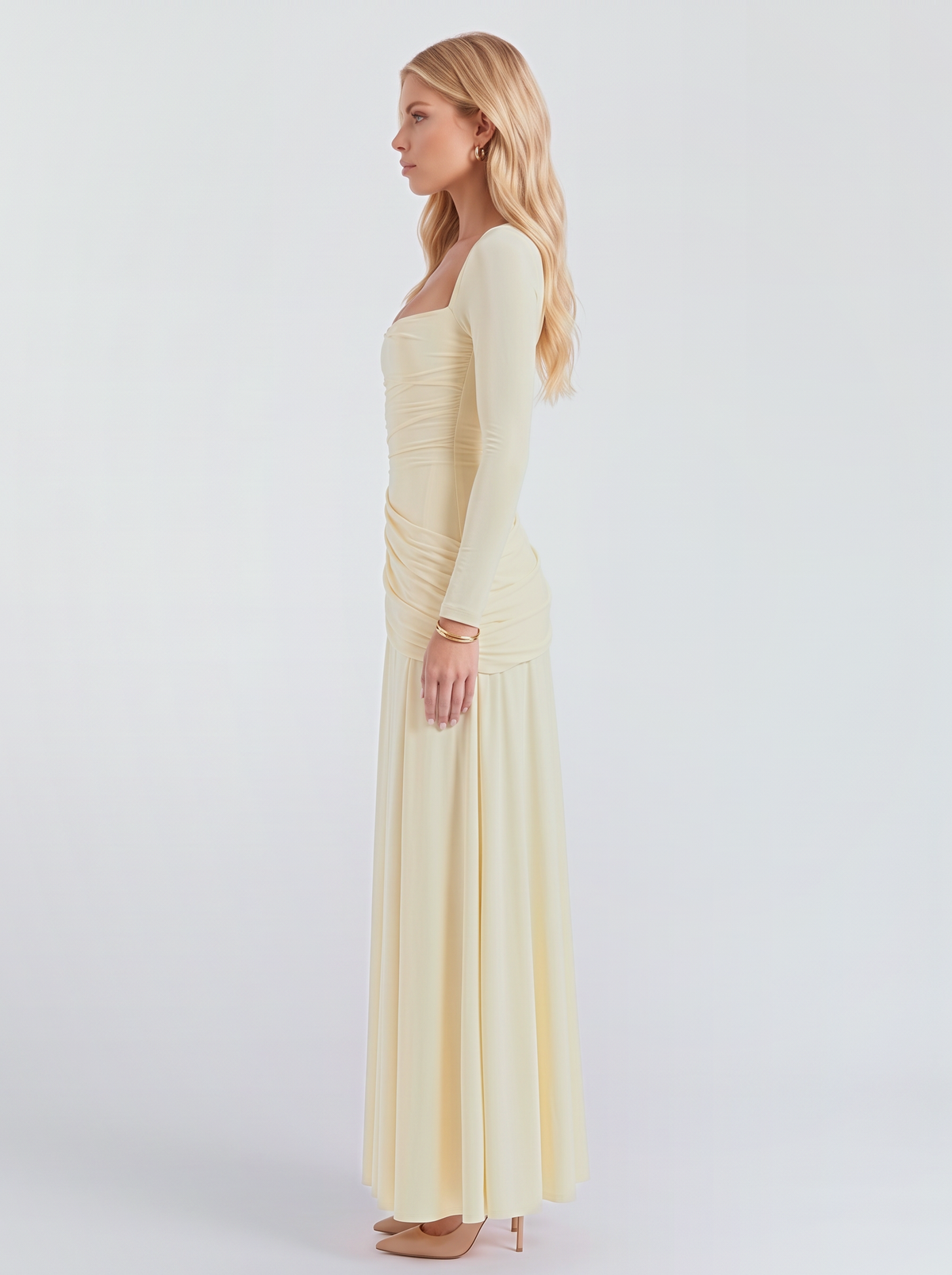 Women cream long sleeve ruched maxi dress with a fitted bodice and a flowing skirt, side view