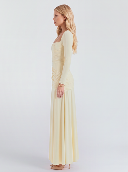 Women cream long sleeve ruched maxi dress with a fitted bodice and a flowing skirt, side view