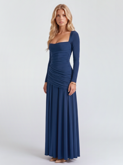 Women navy long sleeve ruched maxi dress with a draped hip and a flowing skirt, three quarter view