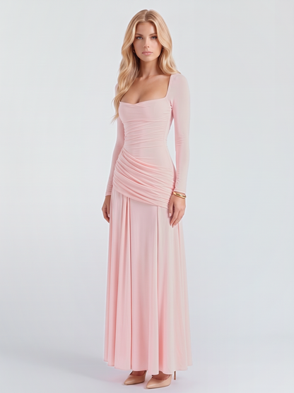 Women pink long sleeve ruched maxi dress with a draped hip and a flowing skirt, three quarter view