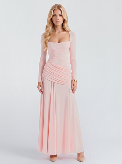 Women pink long sleeve ruched maxi dress with a square neckline and a draped hip, front view