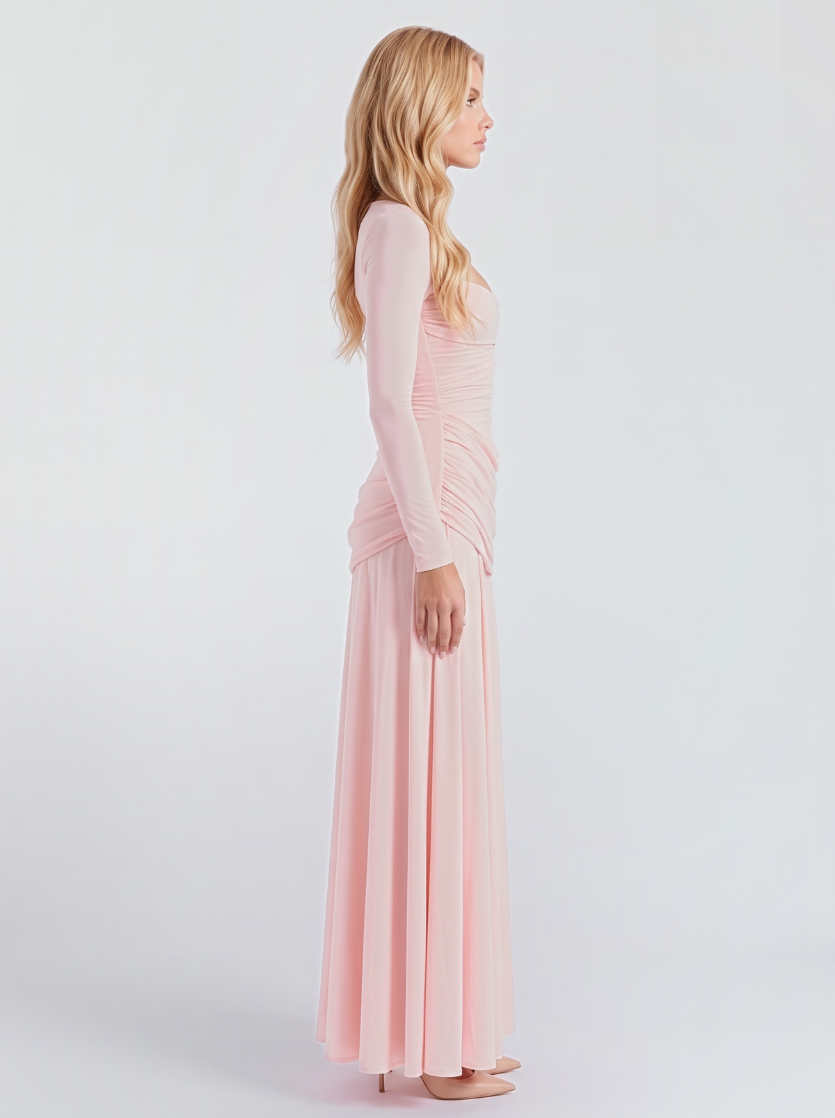 Women pink long sleeve ruched maxi dress with a fitted bodice and a flowing skirt, side view