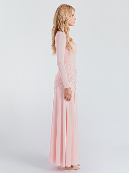 Women pink long sleeve ruched maxi dress with a fitted bodice and a flowing skirt, side view