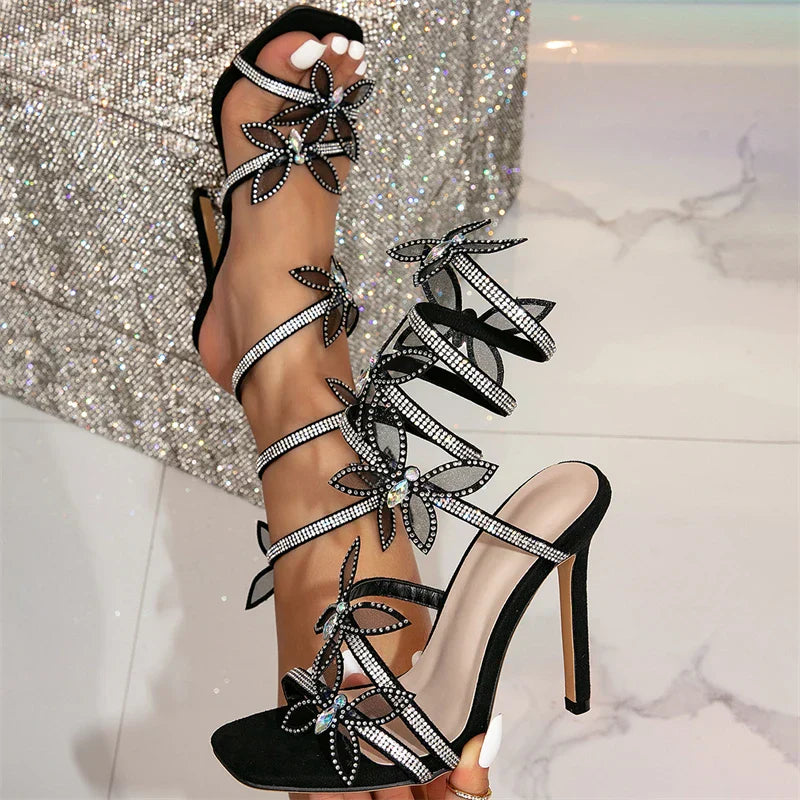 Women black heeled sandals with wrap straps and butterfly detail