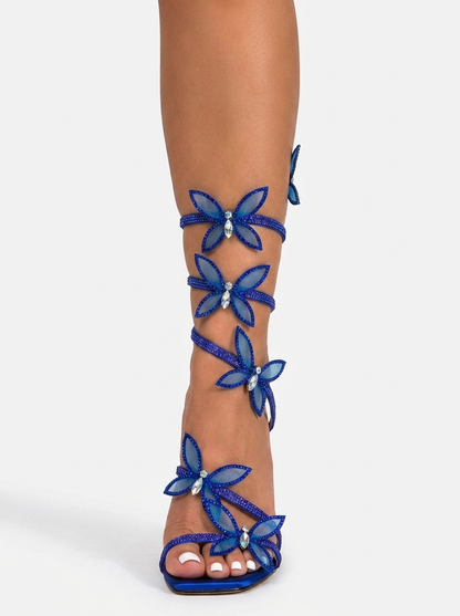 Women blue heeled sandals with wrap straps and butterfly detail