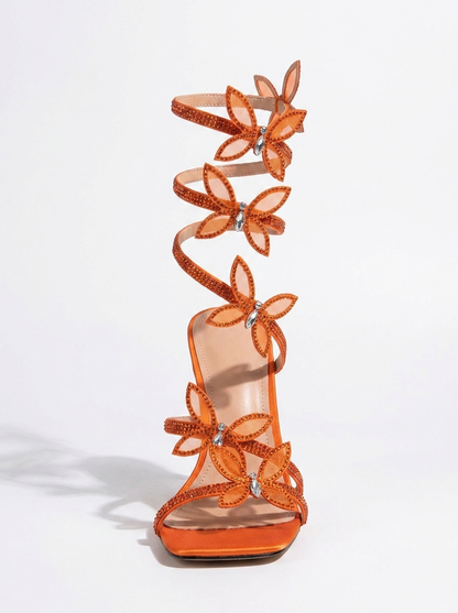 Women orange heeled sandals with wrap straps and butterfly detail