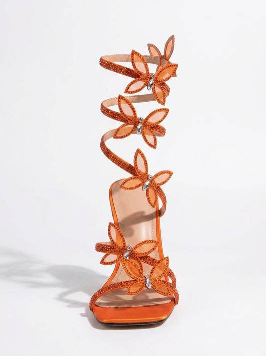 Women orange heeled sandals with wrap straps and butterfly detail