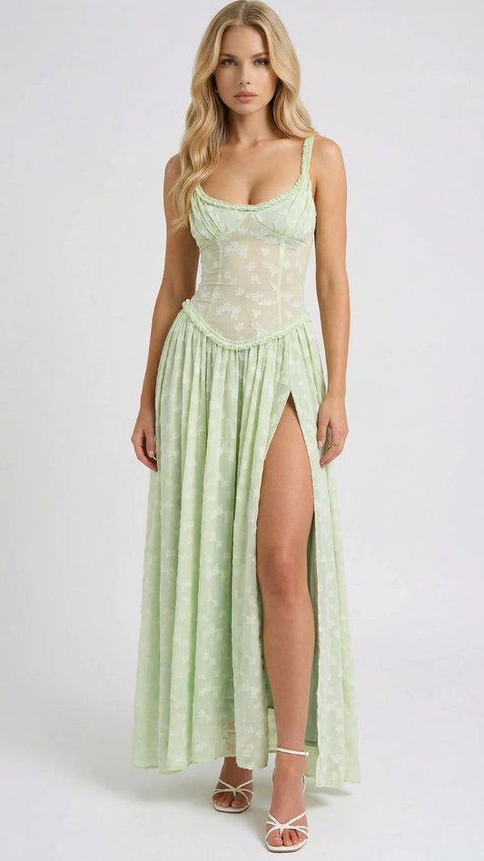 Front view of a light green maxi dress with delicate lace details, a sweetheart neckline, and a high leg slit.