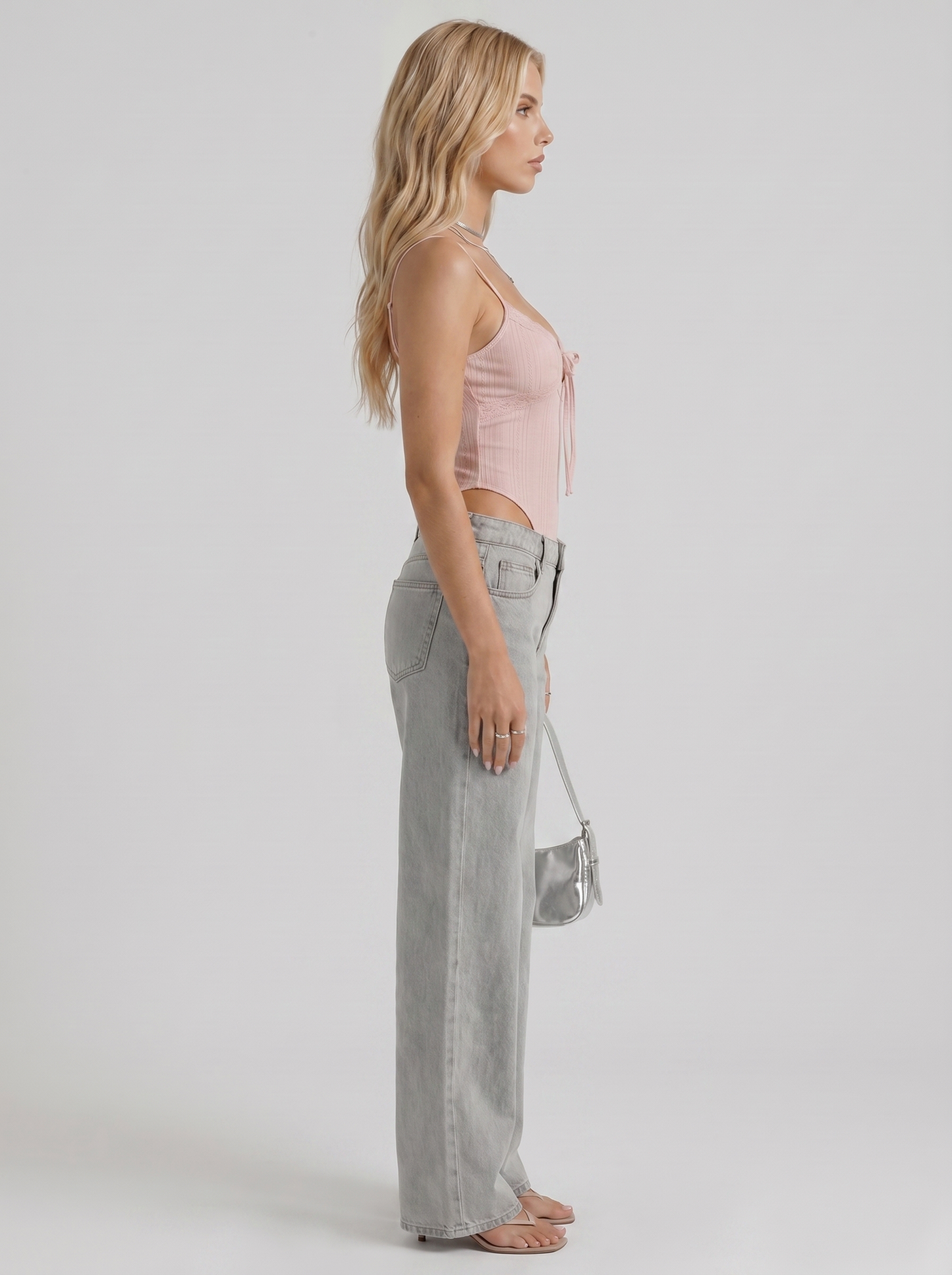 Women blue wide leg bow detail jeans, side profile view