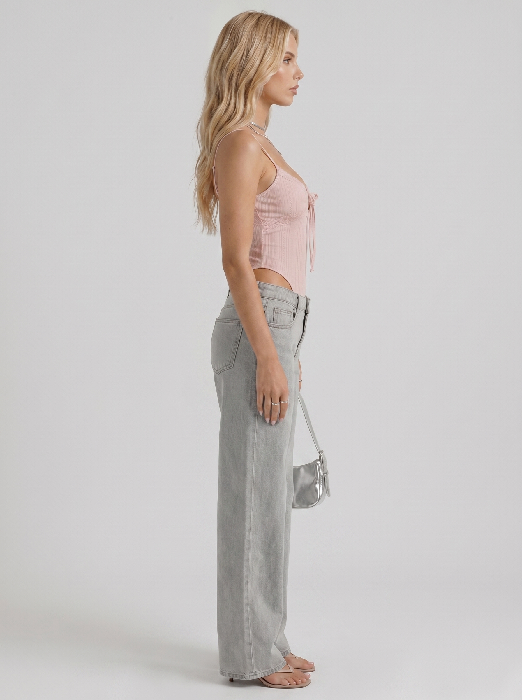 Women blue wide leg bow detail jeans, side profile view