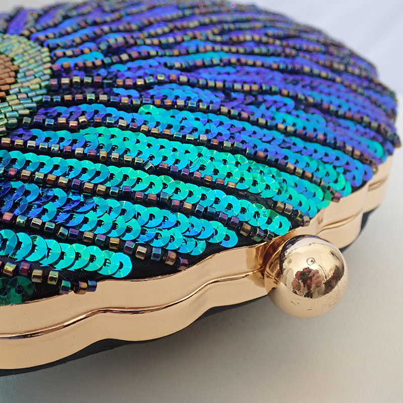 Women blue clutch bag with sequin finish and beaded detail