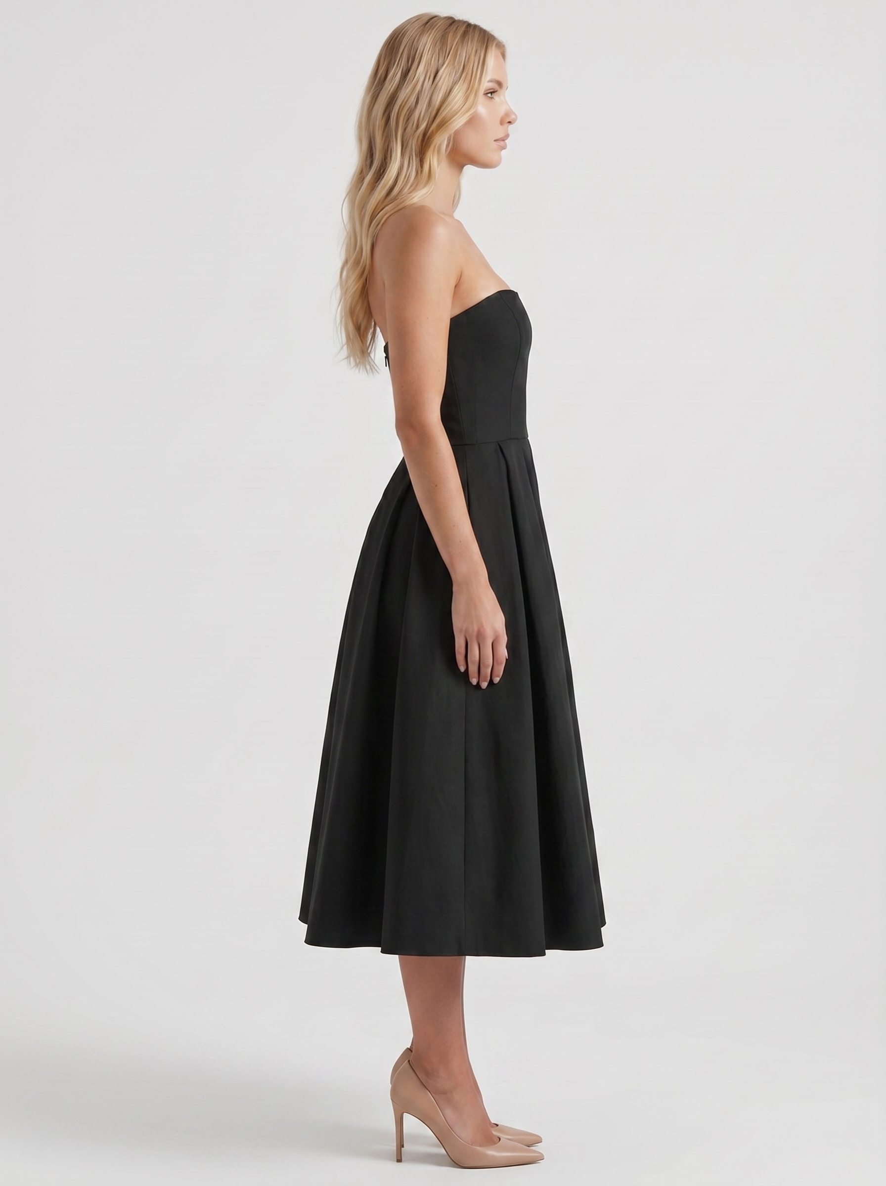 Women black strapless pleated midi dress with fitted bodice, side profile