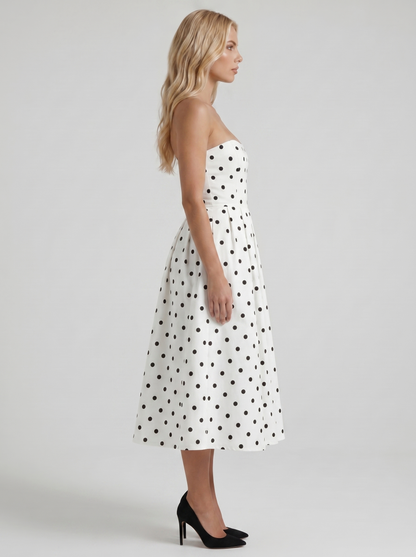 Women black polka dot strapless pleated midi dress with fitted bodice, side profile