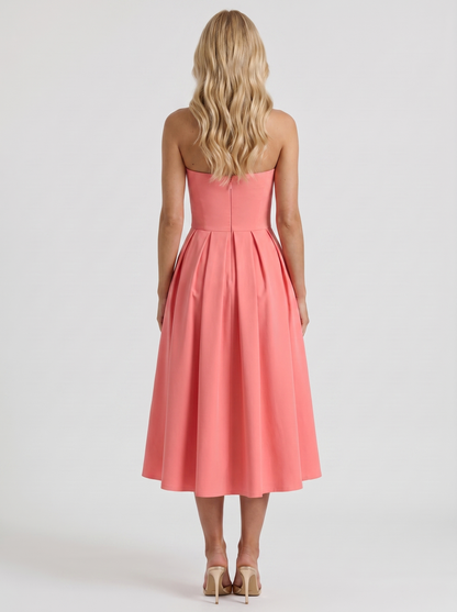 Women coral pink strapless pleated midi dress with open back, back view