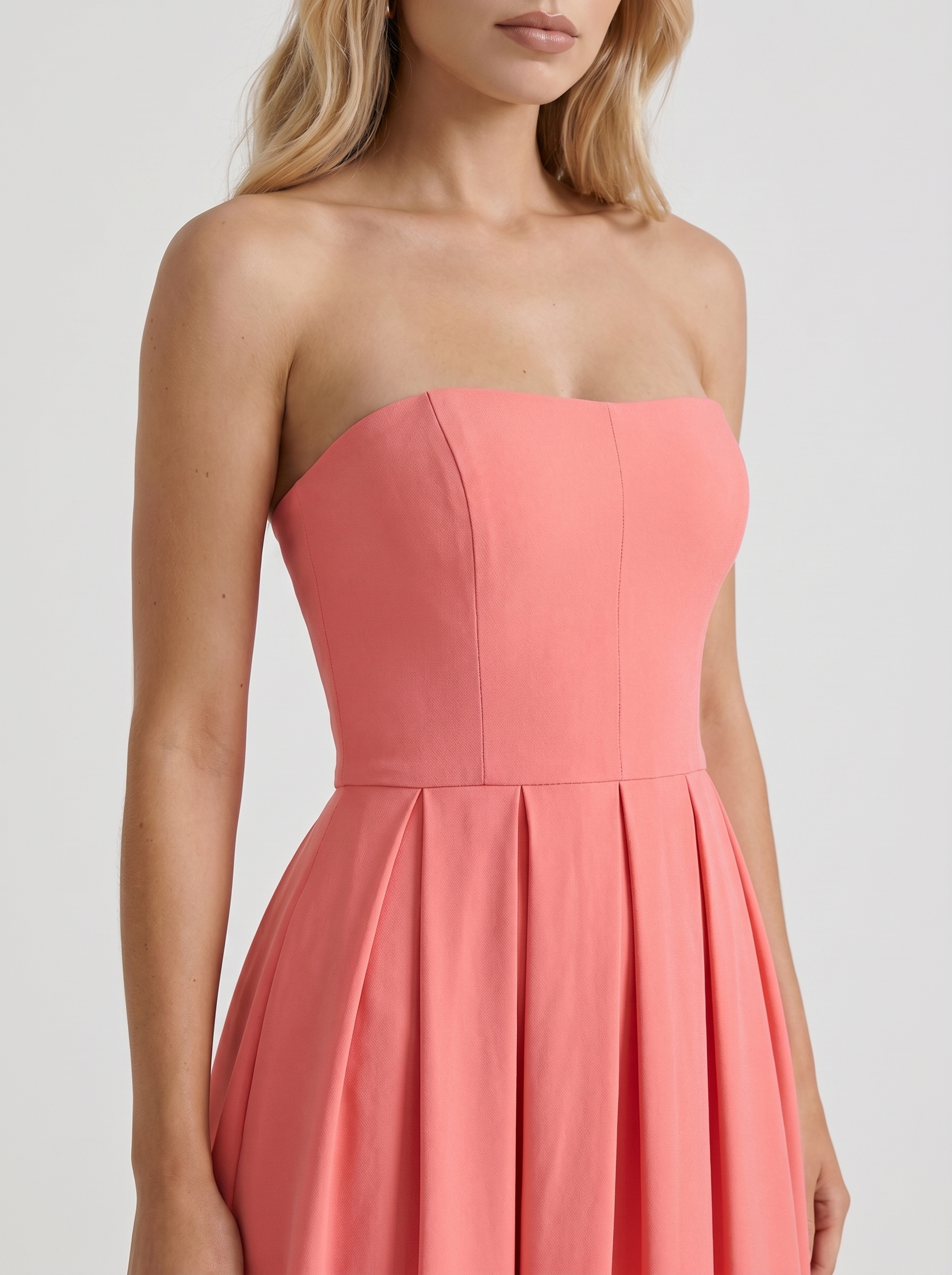 Women coral pink strapless pleated midi dress closeup of bodice and pleat detail