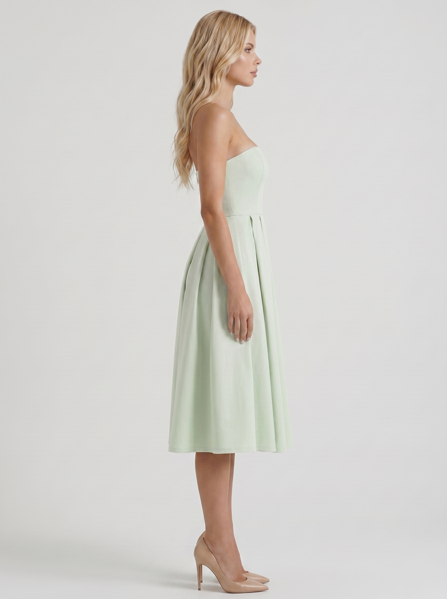 Women mint strapless pleated midi dress with fitted bodice, side profile
