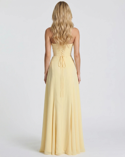 Women yellow corset maxi dress with fitted body and mermaid skirt, side profile