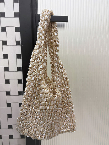 Women ivory shoulder bag with shell detail and woven body