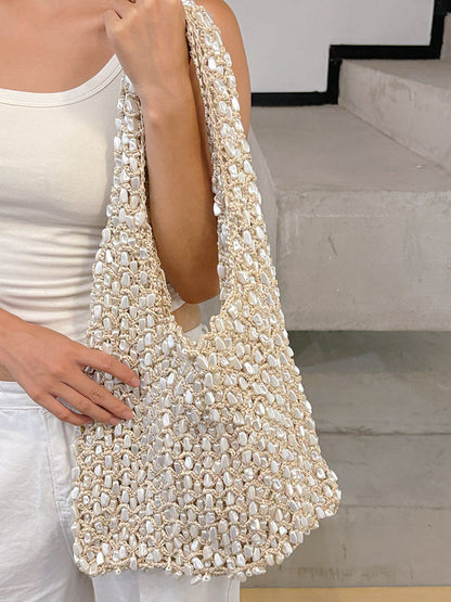 Women ivory shoulder bag with shell detail and woven body