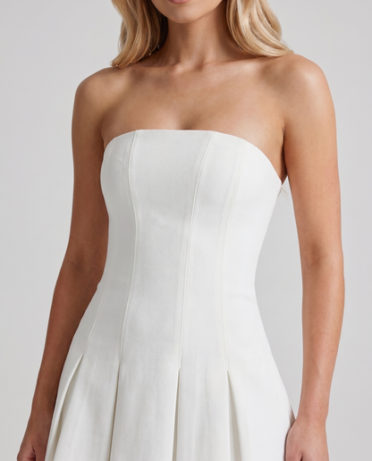 Women ivory strapless mini dress closeup of straight neckline, fitted bodice, and paneled seams