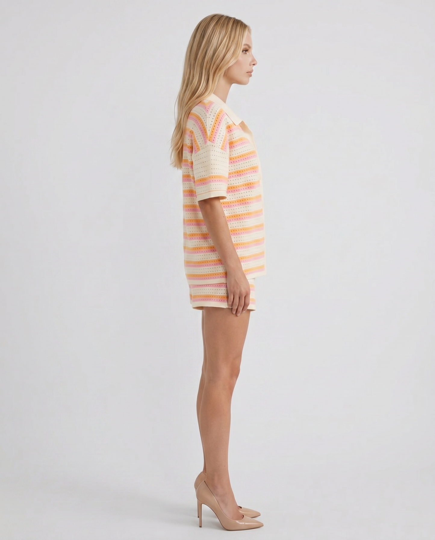 Women cream striped polo top and shorts set with relaxed silhouette, side profile