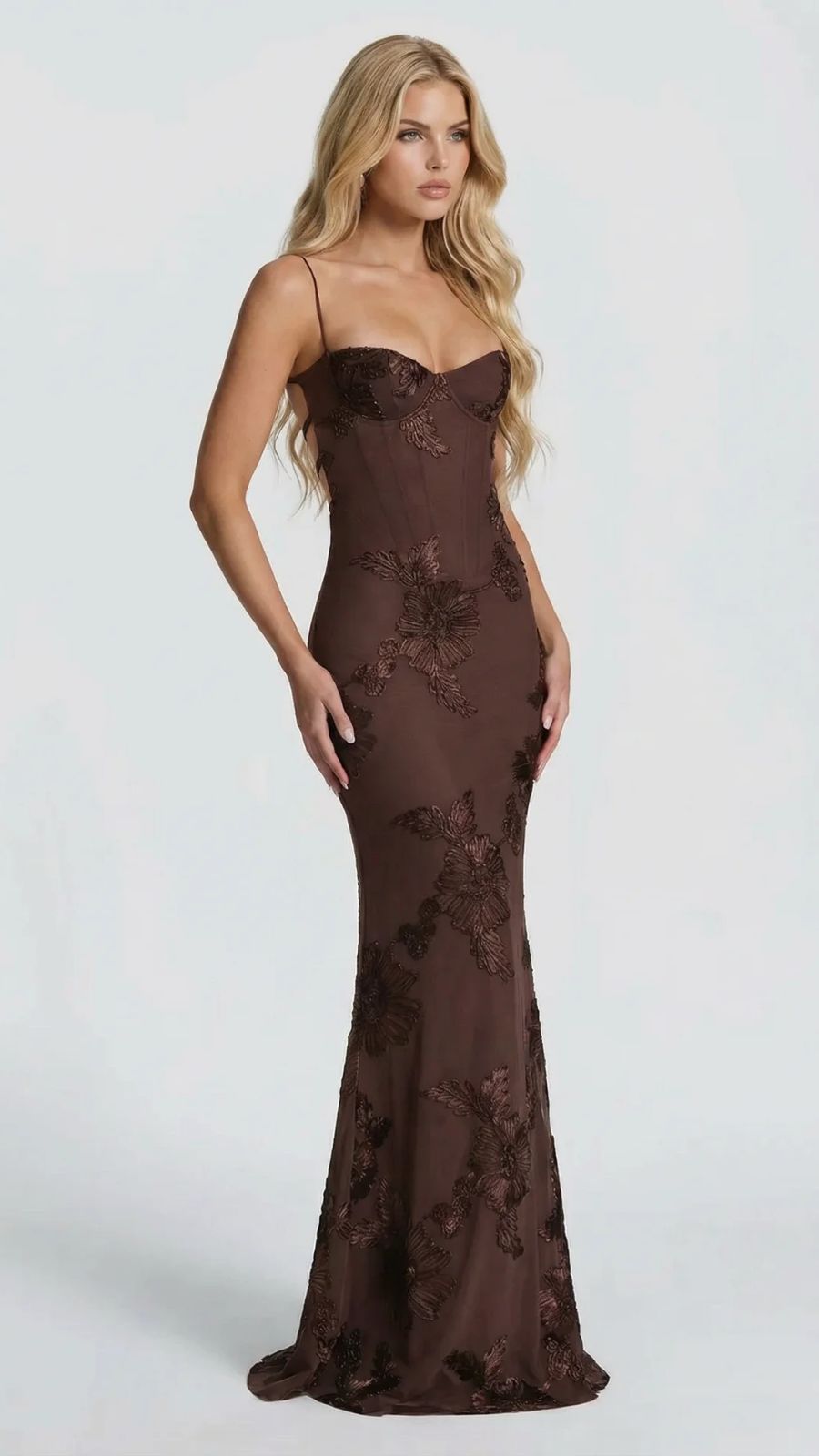Side view of brown floral maxi dress with intricate embroidery, showcasing the fitted waist and flowing skirt.
