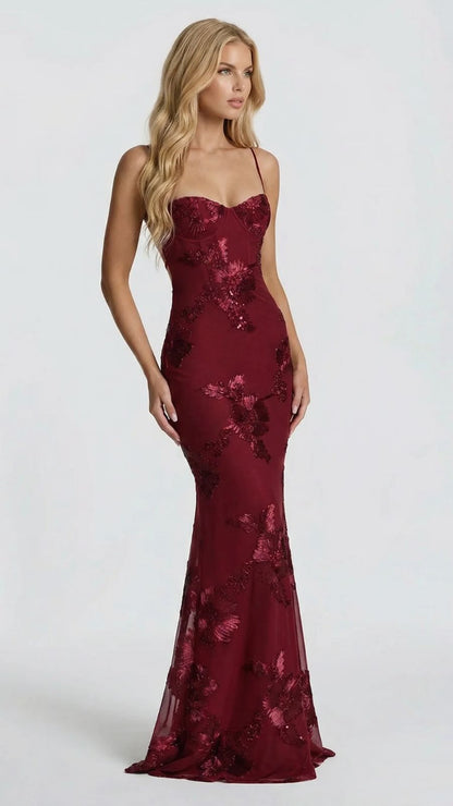 Side angle of the burgundy floral maxi dress, highlighting the flowing skirt and embroidered details