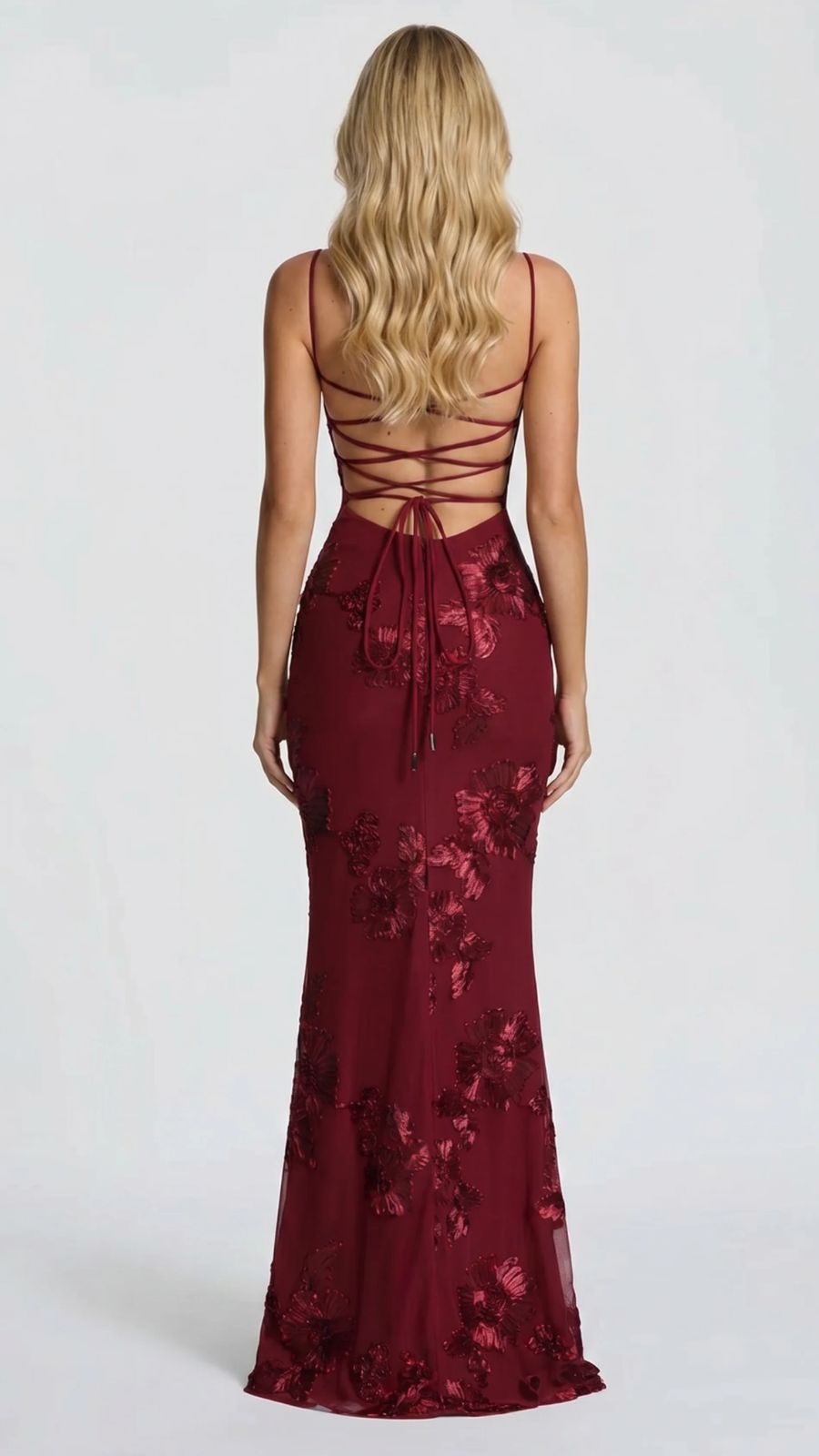 Back view of the burgundy floral maxi dress, featuring a lace-up back detail and sweeping train