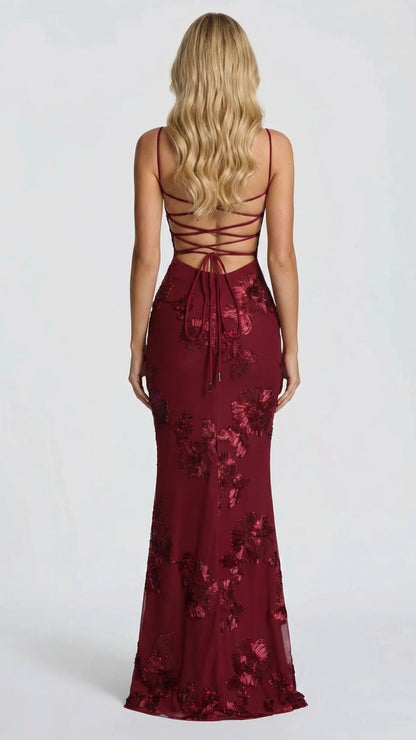 Back view of the burgundy floral maxi dress, featuring a lace-up back detail and sweeping train