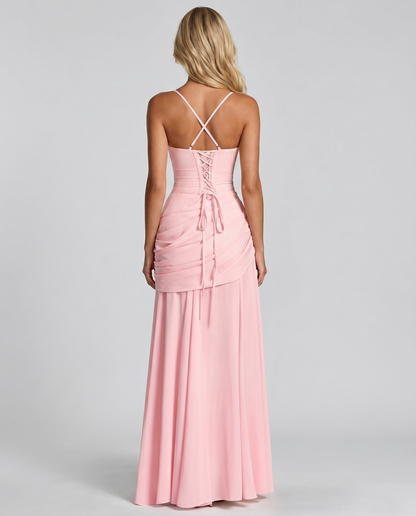 Back view of pink ruched maxi dress with crisscross straps, lace-up back and flowing hem