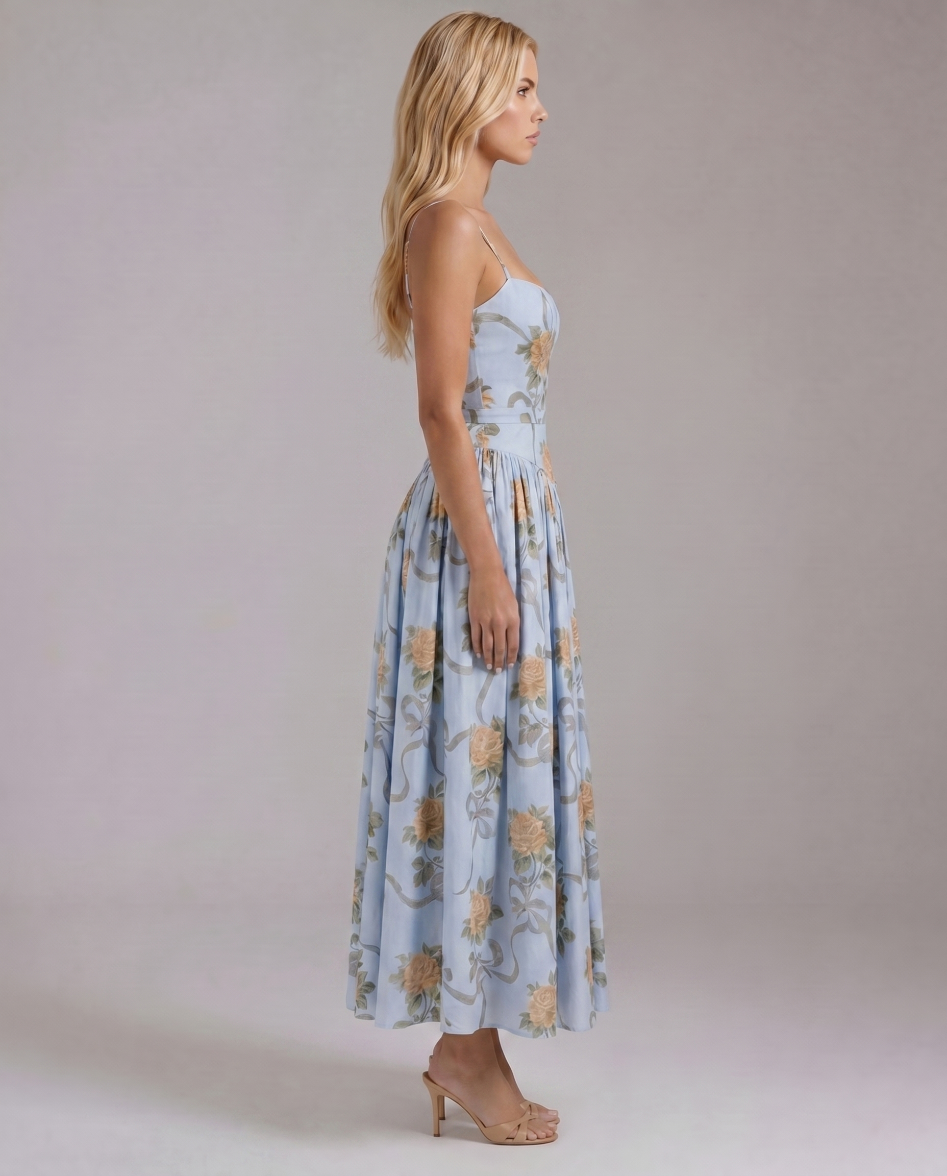 Side profile vintage blue floral midi dress with spaghetti straps, defined waist seam, and full skirt