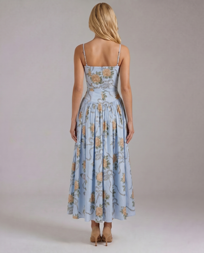 Back view vintage blue floral midi dress with straight back neckline, thin straps, and gathered skirt