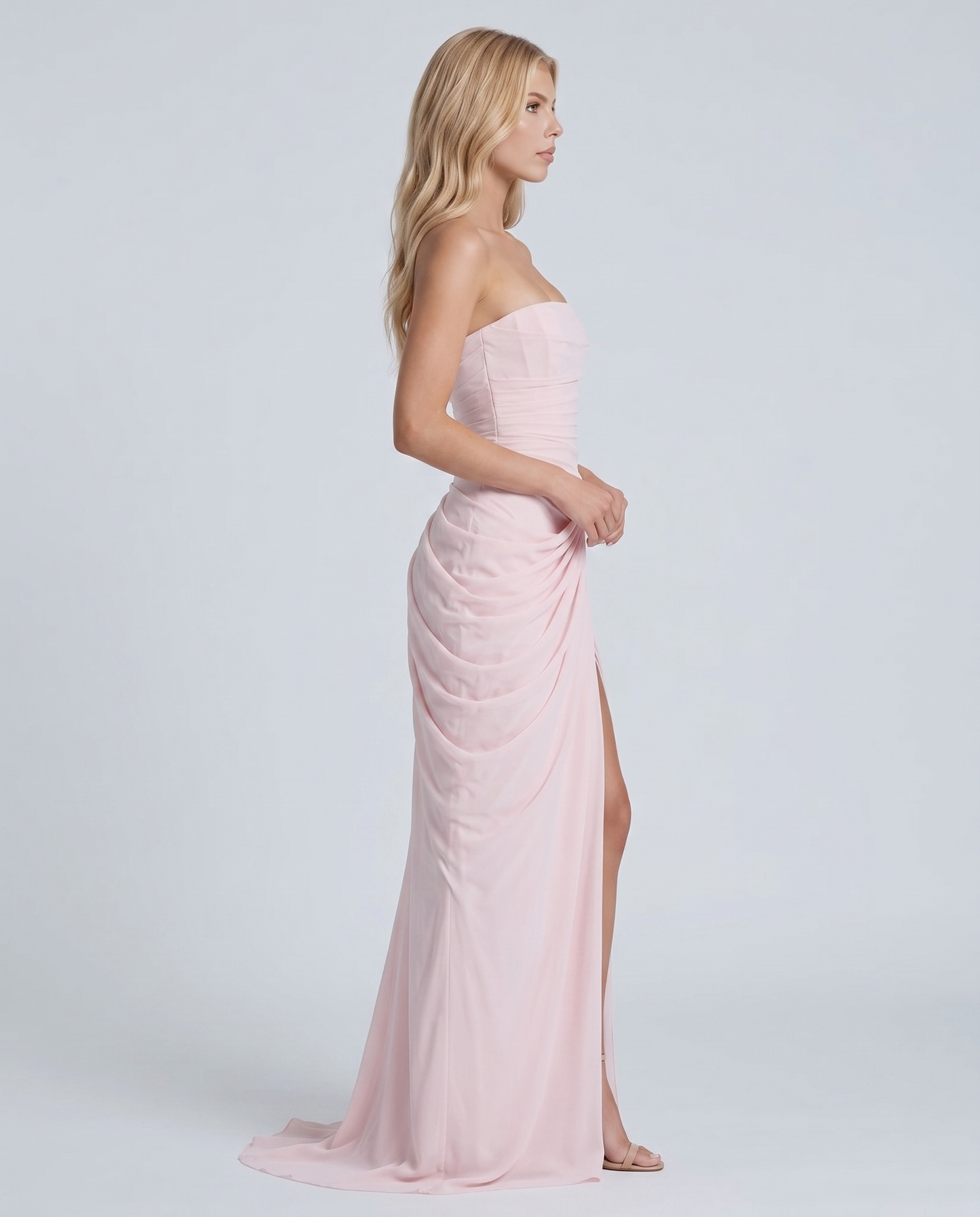 Women's blush pink ruched maxi dress with strapless bandeau neckline and high front slit