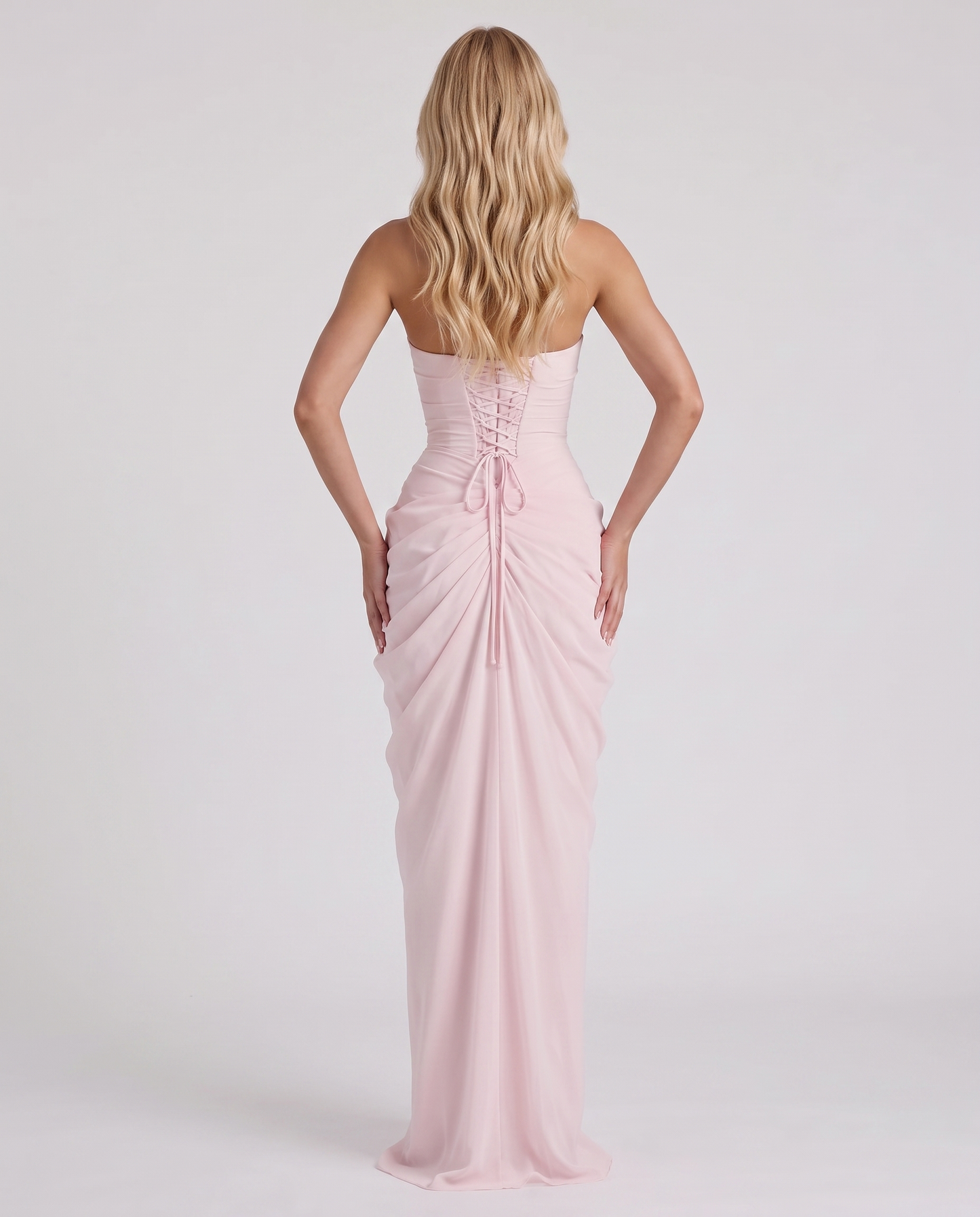Women's blush pink ruched maxi dress with strapless bandeau neckline and high front slit