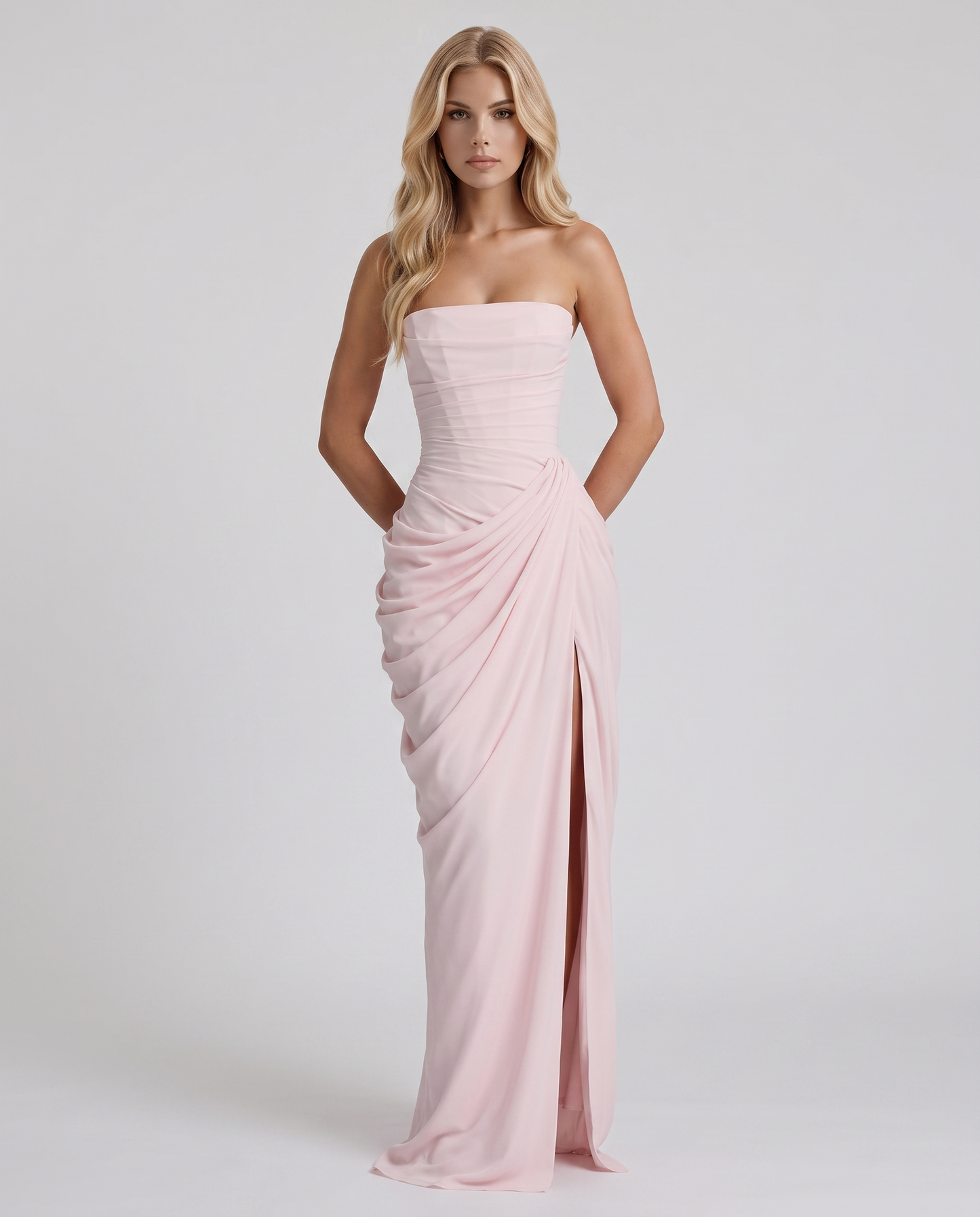 Women's blush pink ruched maxi dress with strapless bandeau neckline and high front slit