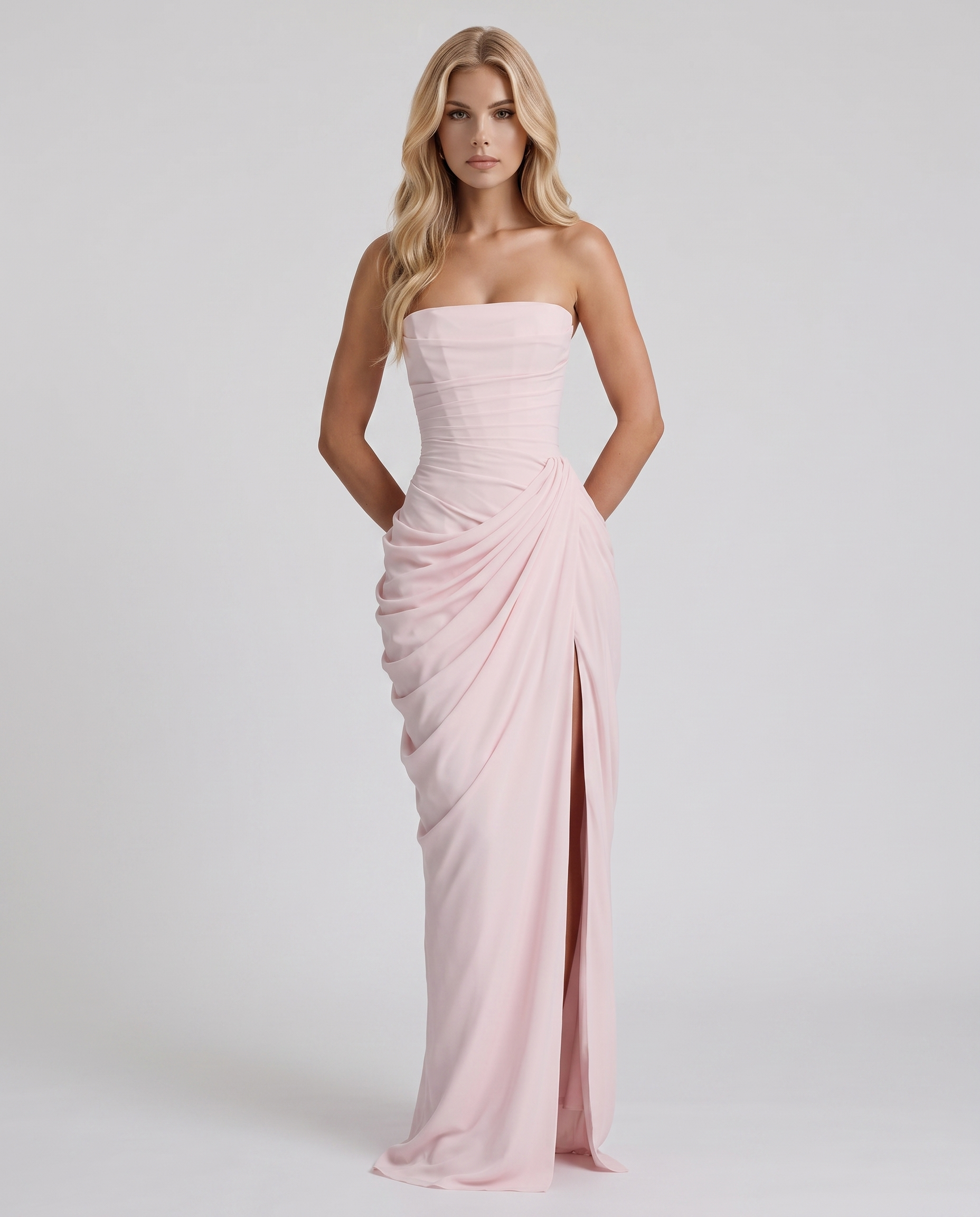 Women's blush pink ruched maxi dress with strapless bandeau neckline and high front slit
