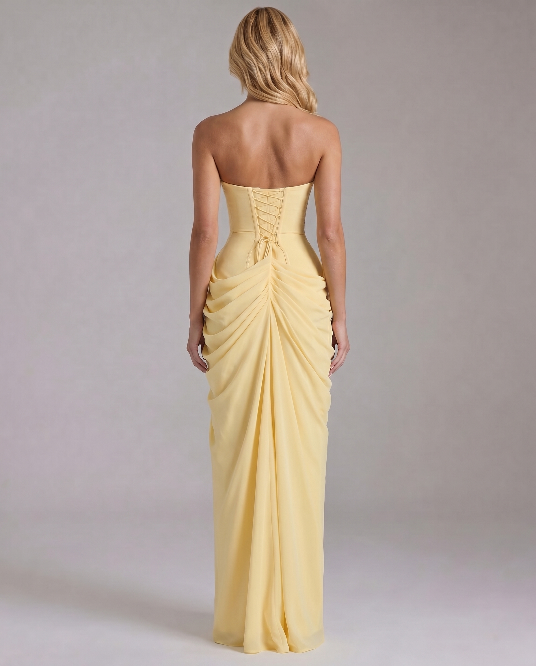 Back view yellow strapless maxi dress showing lace-up corset back and gathered ruching