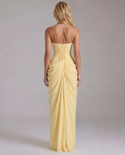 Back view yellow strapless maxi dress showing lace-up corset back and gathered ruching