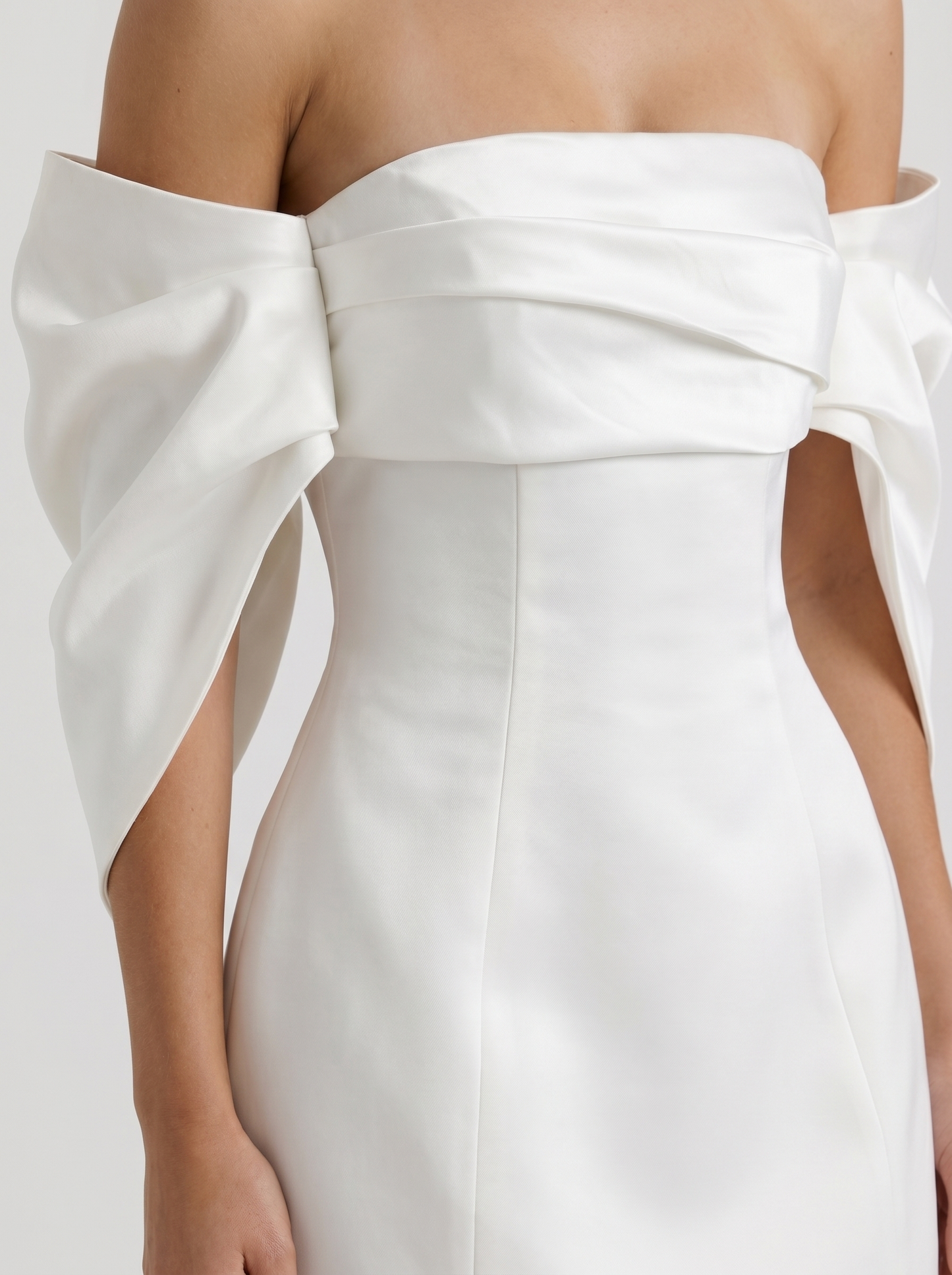 Women ivory off shoulder mini dress closeup of fold over neckline drape