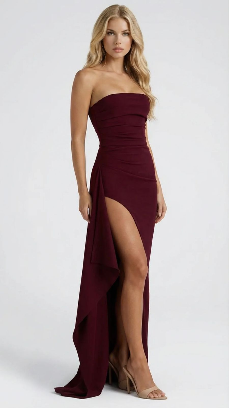 Women's burgundy ruched strapless maxi dress, full front view emphasizing the leg slit and drape.