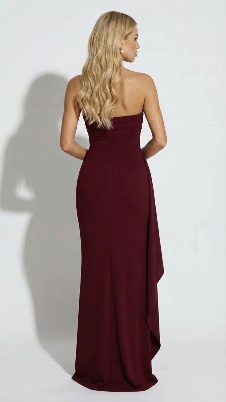 Back view of a women's burgundy strapless maxi dress, showing a smooth, fitted silhouette.