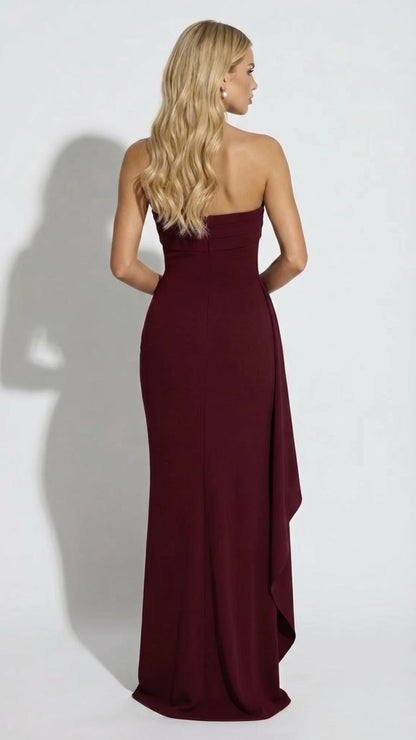 Back view of a women's burgundy strapless maxi dress, showing a smooth, fitted silhouette.
