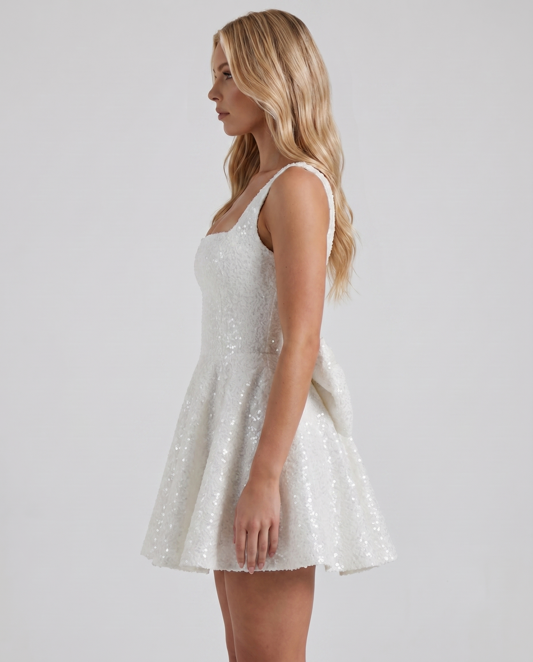Women ivory square neck bow back mini dress with fit and flare silhouette, side view