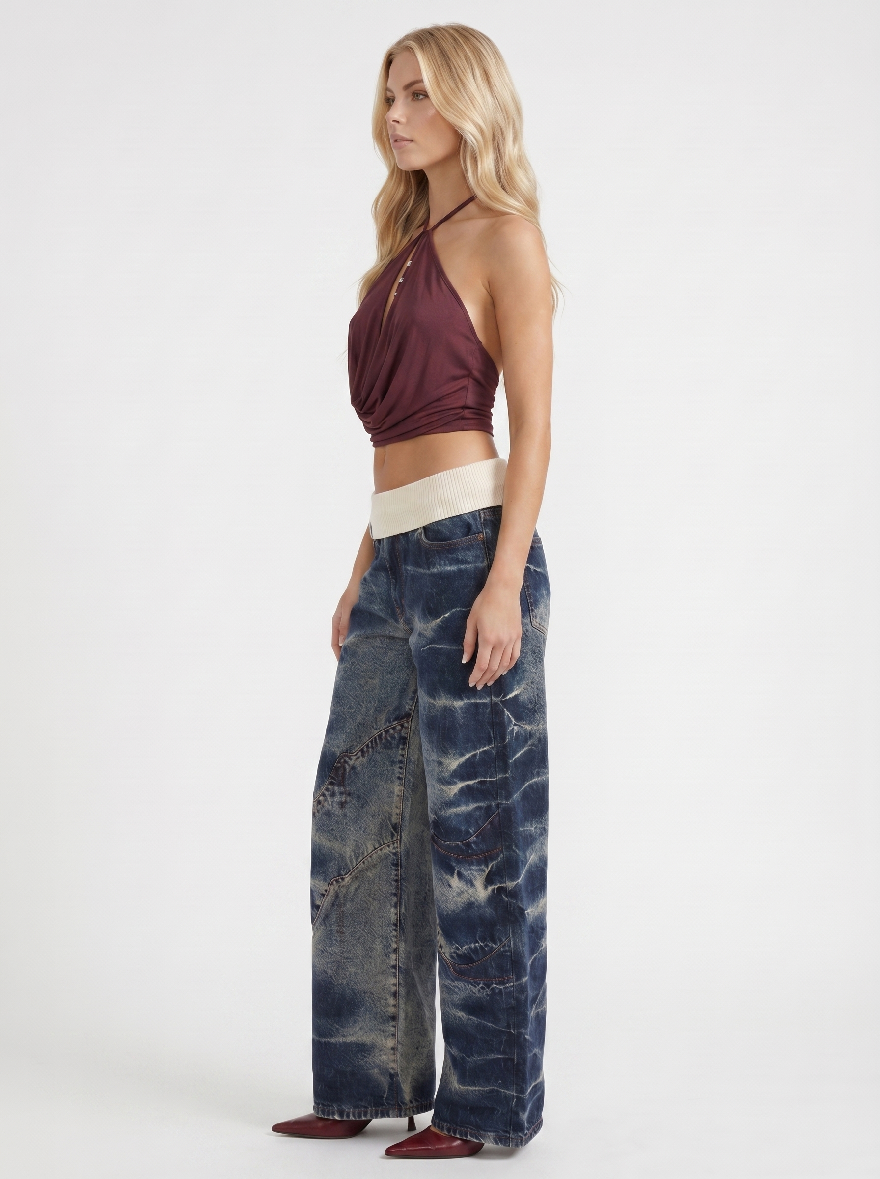 Women dark blue baggy wide leg distressed denim jeans, side profile view