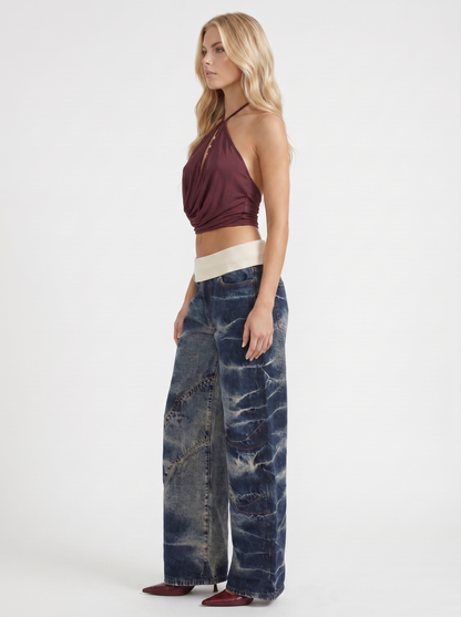 Women dark blue baggy wide leg distressed denim jeans, side profile view