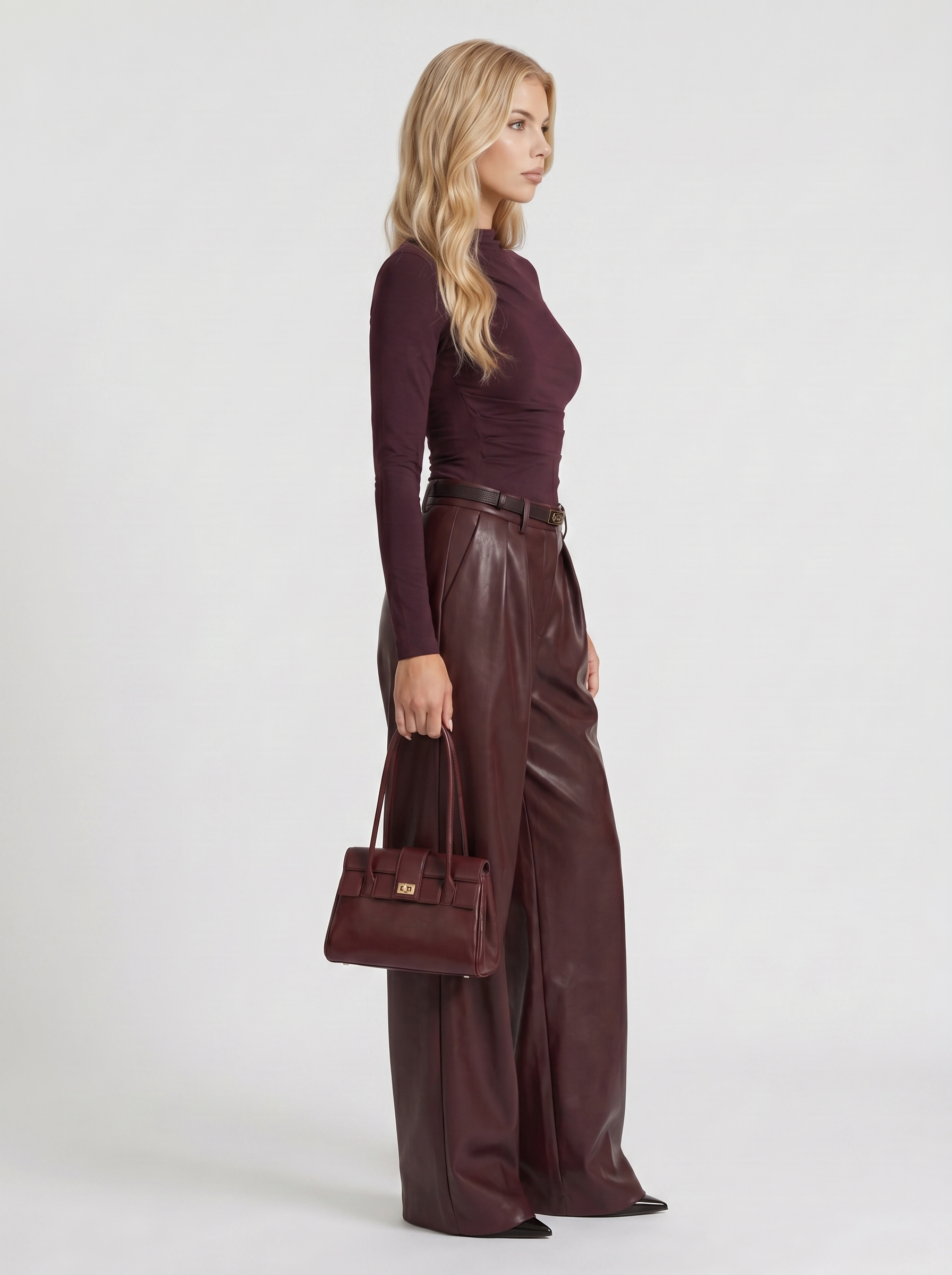 Women plum belted wide leg faux leather pants, side profile view