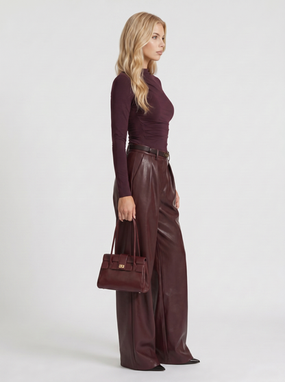 Women plum belted wide leg faux leather pants, side profile view