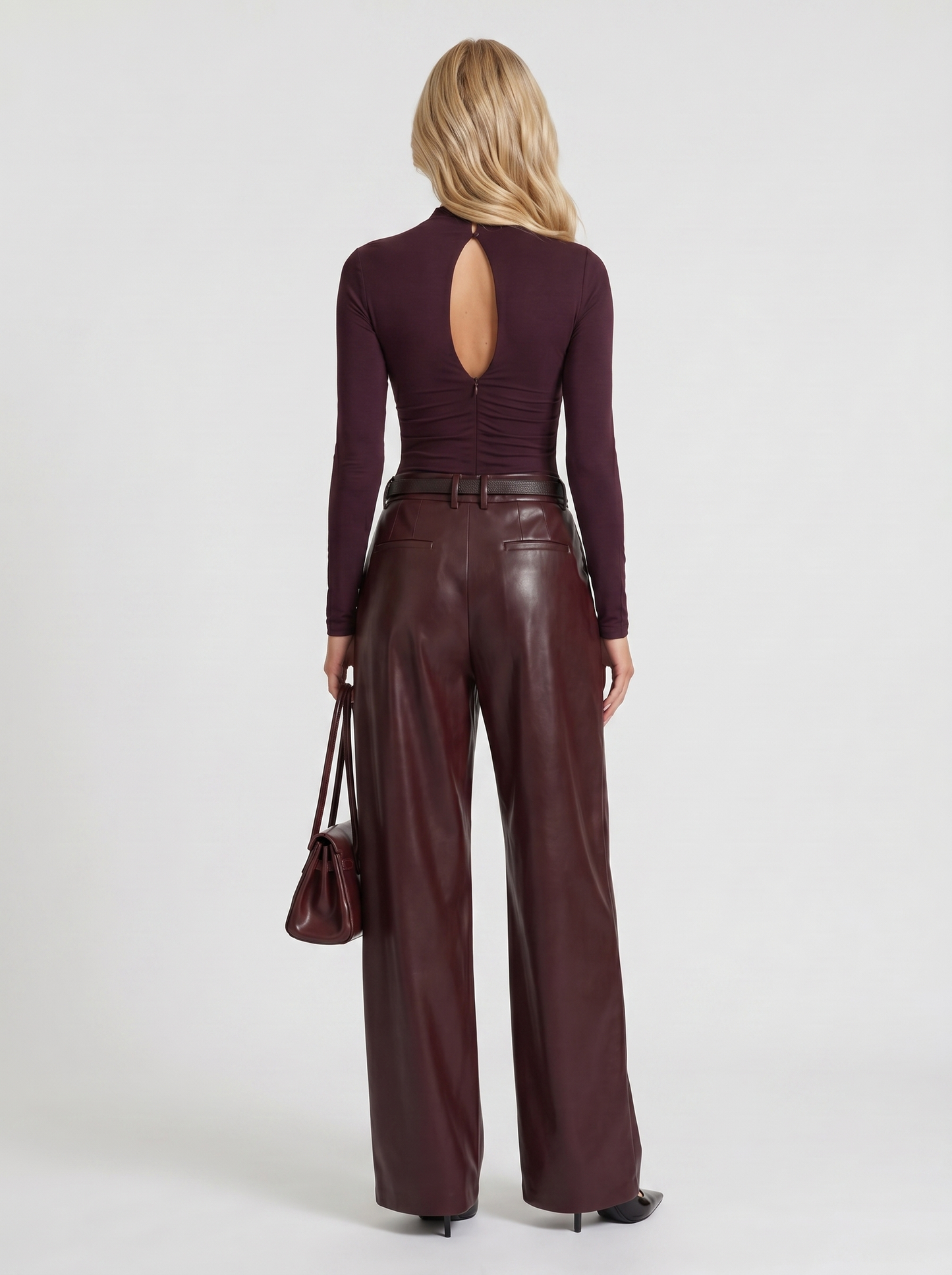 Women plum belted wide leg faux leather pants, back view
